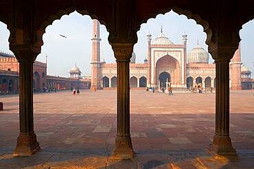 Jama Masjid Mosque Delhi, the courtyard at a mosque, with a colonnade with scalloped edged arches.