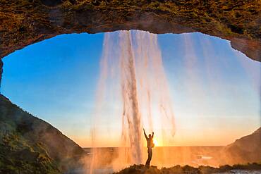 Man behind Seljalandsfoss Waterfall, South Iceland, Iceland