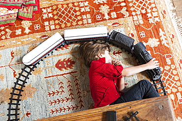 overhead view of young boy playing with his train