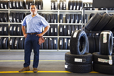 Portrait of Hispanic male owner in auto repair shop