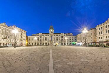 The empty piazza of Unity of Italy square, historic buildings and street lights.