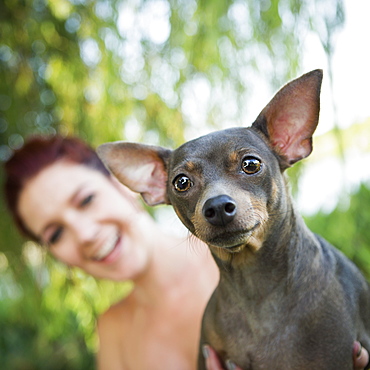 A woman with a small pet dog, Austin, Texas, USA