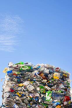 Commercial waste management, bales of recycling materials, plastics stacked up.