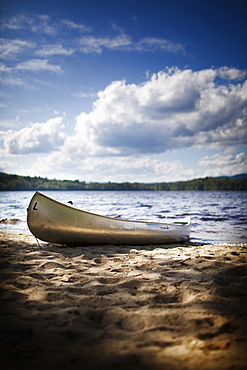 A canoe boat beached on the shore of a lake or river, USA