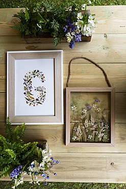 Floral letter G in wooden frame, decorations for a woodland naming ceremony.