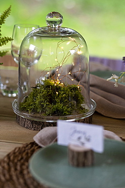 High angle close up of rustic place setting for a woodland naming ceremony.