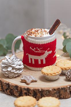 Christmas, mince pies and mug of hot chocolate or eggnog with a knitted wraparound cover