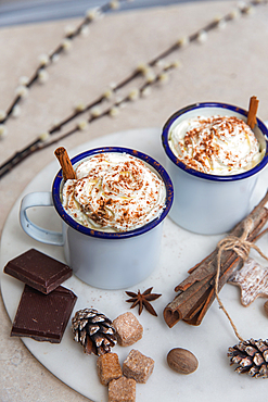 Christmas, mugs of egg nog with whipped cream and candy canes.