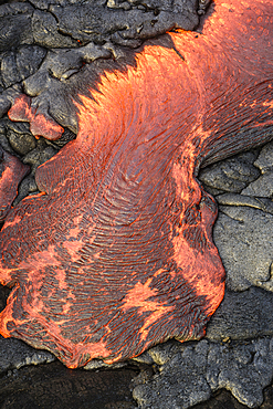 Lava flow over volcanic black rock.