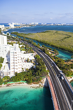 Aerial view over the hotel zone at Cancun, highway and high rise buildings, coastline.