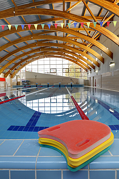 Indoor swimming pool, starting block, diving block and marked lanes, flat calm water