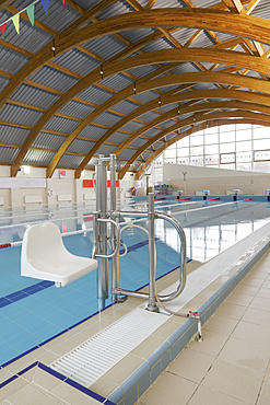 Indoor swimming pool, a chair and hoist for disabled people.