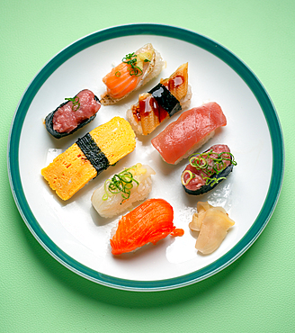 Sushi platter, a selection of raw fish and rice snacks with chopsticks.