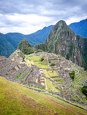 The path to Machu Picchu, the high mountain capital of the Inca tribe, a 15th century citadel site, buildings and view of the plateau and Andes mountains.