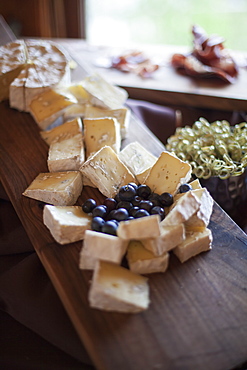 A wedding party meal. A cheeseboard, with soft cheeses cut into triangles, and fresh fruits. Blueberries, Park City, Utah, USA