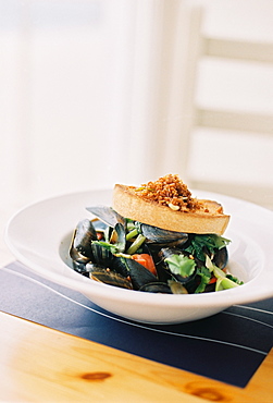 Mussels, shellfish on a white china dish. Garnishes, England