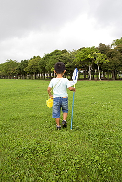 Young boy carrying a butterfly net, Kyoto, Honshu Island, Japan