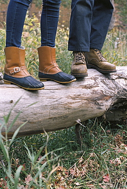 Close up of couple standing side by side on a tree trunk, Millcreek, Utah, United States of America