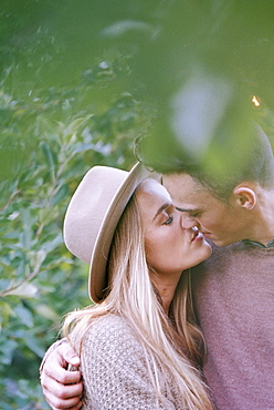 An apple orchard in Utah. A couple kissing, Sataquin, Utah, United States of America