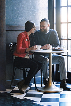 A couple seated side by side at a cafe table, Cafe, Utah, USA