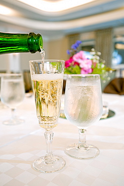 Glasses of champagne and water on table, Palm Beach, Florida, USA