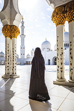 Woman walking at Sheikh Zayed Grand Mosque, Abu Dhabi, United Arab Emirates