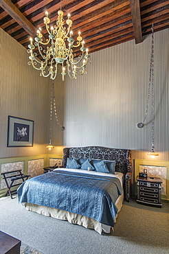 Chandelier over bed in modern hotel room