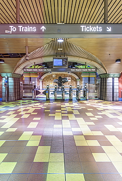 Turnstiles and signs in subway station