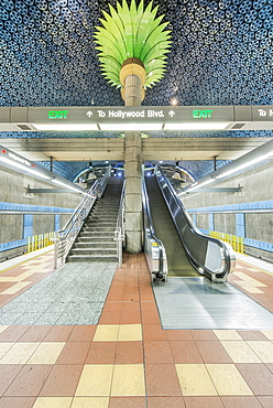 Ornate pillars, escalator and movie reels on ceiling in subway station, Los Angeles, California, United States