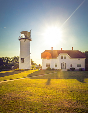 Home and lighthouse on rural lawn