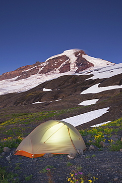 Glowing tent at campsite in remote landscape, North Cascades, Washington, USA