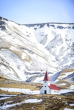 Church under snowy mountains in rural landscape, Vik, Iceland