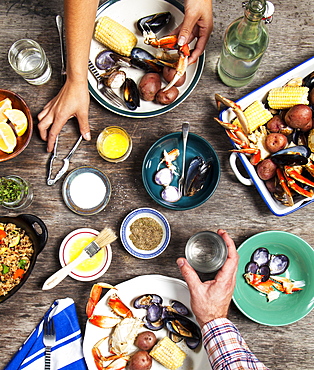 High angle view of hands at seafood dinner, Seattle, Washington, USA