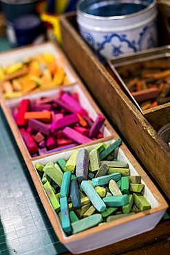 High angle close up of artist's crayons in a variety of vibrant colours, Oxfordshire, England