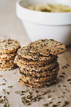 High angle close up of stack of freshly baked seeded crackers, England