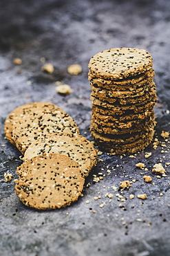 High angle close up of stack of freshly baked seeded crackers, England