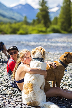 13 year old teen girl embracing her dog, CO, Crested Butte