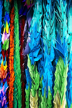 Close up of colourful origami cranes, a symbol of peace, decorating an altar, Kyushu, Japan