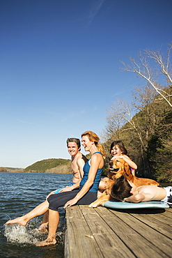 A family and their retriever dog on a jetty by a lake, Austin, Texas, USA