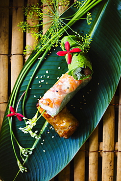 High angle close up of Vietnamese spring rolls served on a banana leaf, Vietnam