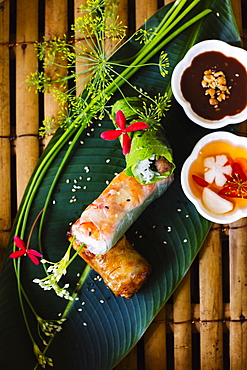 High angle close up of Vietnamese spring rolls served on a banana leaf, Vietnam