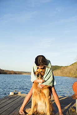 A girl cuddling a golden retriever dog, Austin, Texas, USA