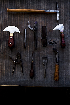 High angle close up of selection of saddle making hand tools, Berkshire, United Kingdom