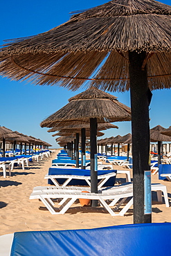 Beach parasols and sunloungers on the beach on Ilha de Tavira, Southern Algarve, Portugal