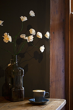 Close up of cup of Cappuccino on a rustic wooden table in a cafe