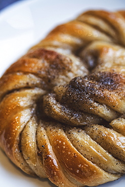 A platted glazed fresh baked cinnamon bun