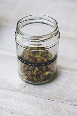 A jar of pistachios with a label, home made Christmas presents