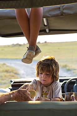 5 year old boy in safari vehicle, Kalahari Desert, Makgadikgadi Salt Pans, Botswana