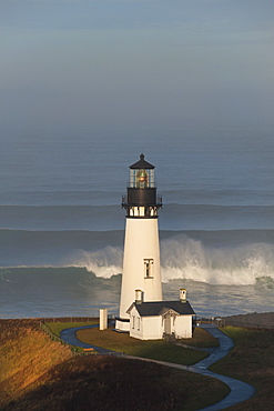 The historic Yaquina Head tower lighthouse on a headland overlooking the Pacific coastline, Yaquina Head, Oregon, USA