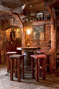 A hotel with old fashioned retro styled rooms, and rustic objects, bar table and stools, Estonia